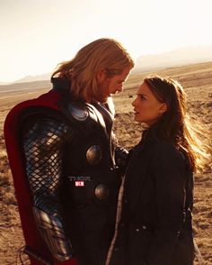 a man and woman standing in the desert