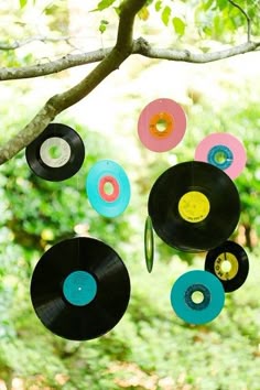 a mobile made out of vinyl records hanging from a tree