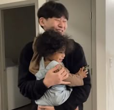 a man holding a child in his arms