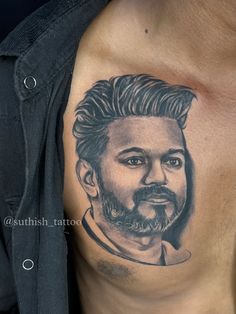 a man with a beard and mustache tattoo on his chest