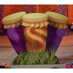 there is a purple and yellow drum in the grass