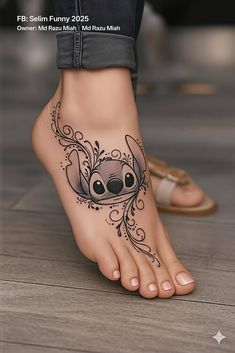a woman's foot with an artistic tattoo design on the bottom of her toe