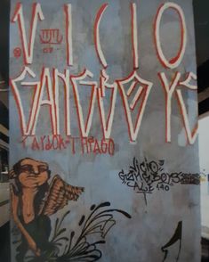 graffiti on the side of a building with words written in red and white spray paint