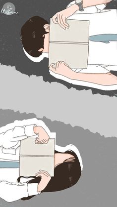 two people are laying on the ground and one is holding a box with something in it