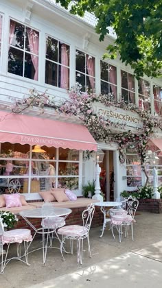 an outdoor cafe with pink and white decor