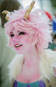 a woman with pink hair and horns on her head