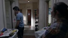 a man and woman are standing in the hallway