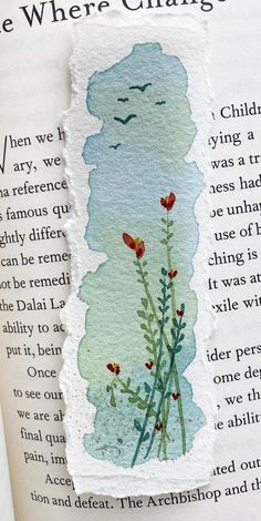 an open book with a drawing of flowers and birds on the page, which reads we where change