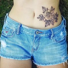 a woman with a flower tattoo on her stomach