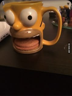 a yellow mug with an angry face on it