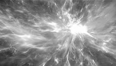 an abstract black and white photo with some light coming from the center in the middle