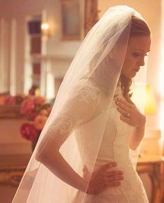 a woman in a wedding dress and veil