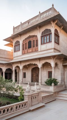 an old building with many windows and balconies on the outside, in india