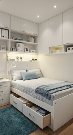 a white bed with drawers underneath it in a room that has blue carpet and wooden flooring