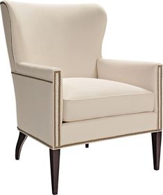 an upholstered white chair with nail - tipped trimmings on the arms