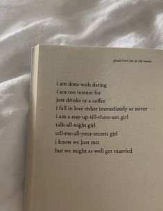 an open book sitting on top of a bed