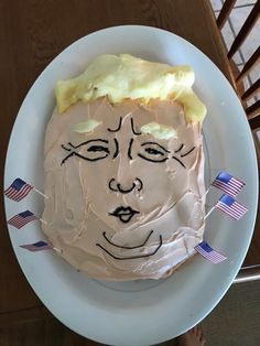 a white plate topped with a frosted face on top of a table next to an american flag