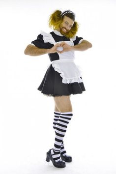 a woman dressed in black and white posing for the camera with her hands on her hips