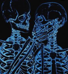 two skeletons with crossed arms in blue light