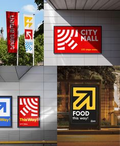 four different signs on the side of a building with trees and buildings in the background