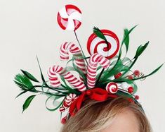 a woman wearing a candy cane headpiece