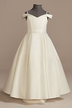 a white dress on a mannequin dummy with a black top and bow at the waist