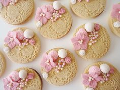 many decorated cookies with pink and white decorations