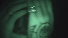 a blurry image of a woman's face in the dark with green light