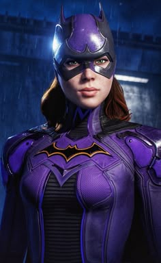 a woman dressed as batgirl standing in the rain