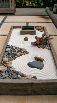a garden with rocks and stones in the center, on top of a tile floor