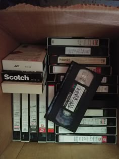 a cardboard box filled with lots of different types of dvd's