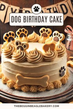 a dog birthday cake with frosting and paw prints on the icing is ready to be eaten