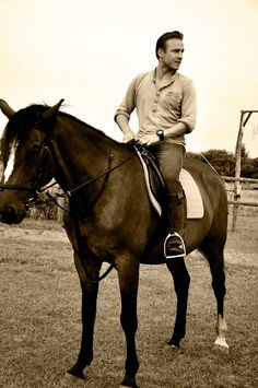 a man riding on the back of a brown horse