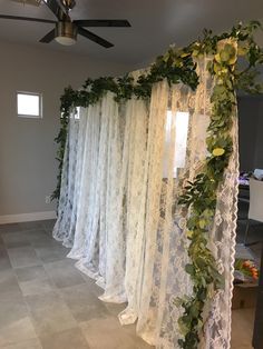 the room is decorated with white lace and greenery
