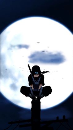 a person sitting in front of a full moon