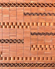 a wall made out of bricks with circles and holes in the middle on each side