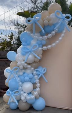 balloon arch with blue and white balloons attached to it