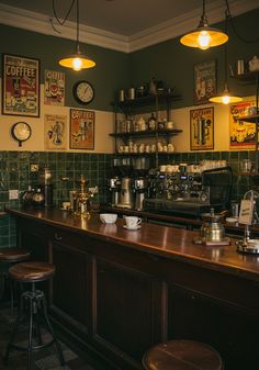 an old fashioned coffee shop with green tile and wooden counter tops, two stools at the bar