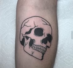 a man with a skull and fish tattoo on his arm