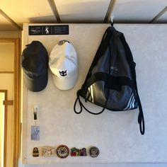 there is a backpack, hat and other items on the wall