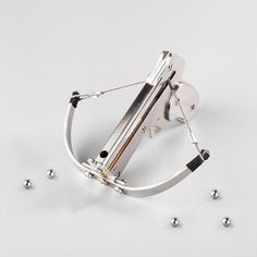 a pair of scissor handles with balls around them