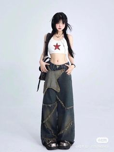 a woman with long black hair is wearing jeans and a white crop top, while standing in front of a gray background