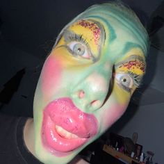 a woman with painted face and tongue sticking out