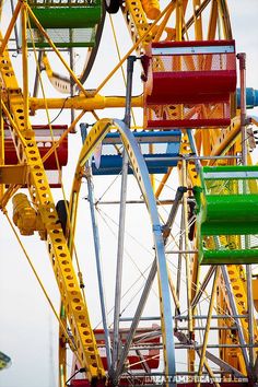 the ferris wheel is brightly colored and empty