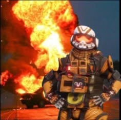 a firefighter standing in front of a large explosion