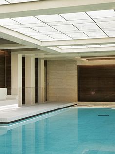 a large indoor swimming pool with skylights