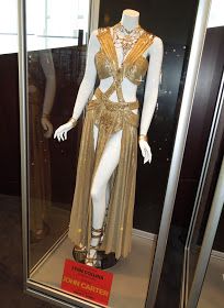 Princess Dejah Thoris Carter movie costume John Carter Princess, Cleopatra Movie Outfits, Queen Of The Nile Costume, Queen Of Nile Costume, Jacqueline Durran Costumes, John Carter Dejah Thoris, Cleo Patra Dress, Gold Egyptian Dress, Cleopatra Movie Costumes