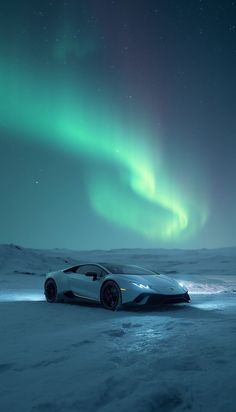 a white sports car parked in the snow under an aurora bore