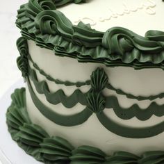 a large green and white cake on a plate