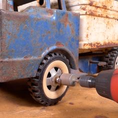 an electric drill is being used to fix a truck tire